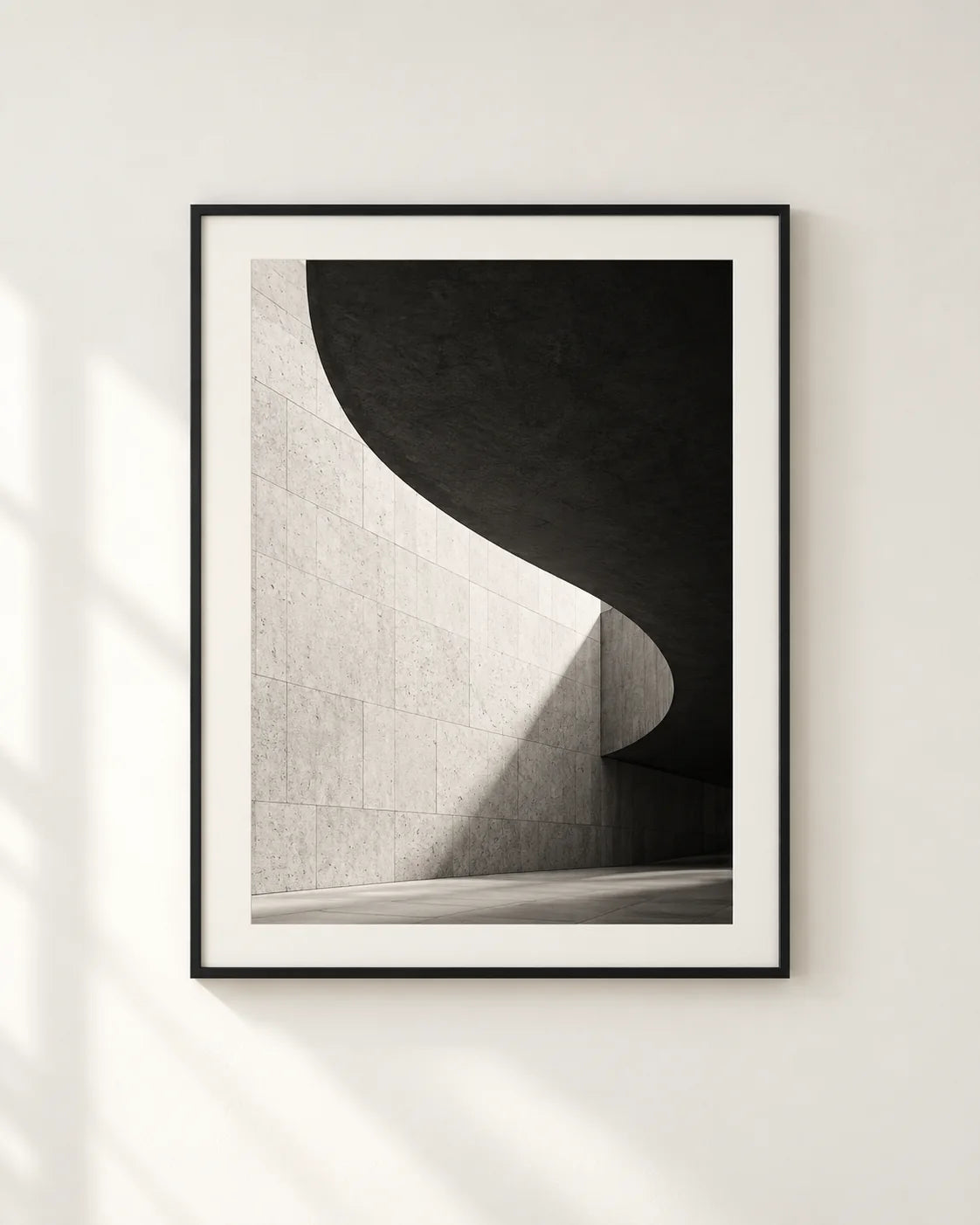 Black and white framed poster in a neutral interior